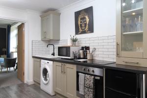 a kitchen with a washer and dryer on a counter at No5, One-Bedroom Apartment, Willowbrook House in Bedworth