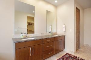 a bathroom with a sink and a large mirror at Red Rock Escape with Suite in St. George +23 photos