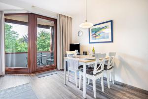 a dining room with a white table and chairs at Apartement Bublitz in Travemünde