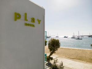 a sign for a hotel with a view of a harbor at Play Paros in Kampos Paros