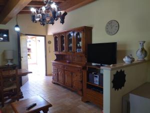 a living room with a large wooden entertainment center with a tv at LoChaletCivico46 in Rome