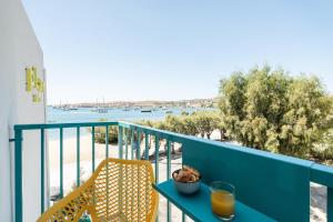 a table and chairs on a balcony with a view of the water at Play Paros in Kampos Paros