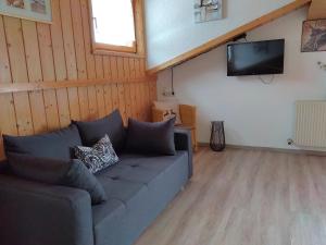 a living room with a couch and a flat screen tv at Haus Monika in Nesselwängle