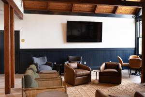 a waiting room with chairs and a flat screen tv at The Lodge at Lincoln Peak at Sugarbush in Warren