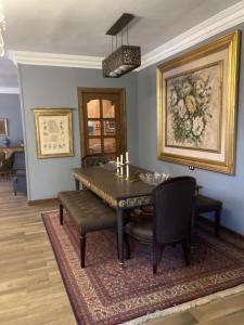 a dining room with a table and some chairs at Grand Egyptian Museum Classic Pyramids Inn in ‘Ezbet `Abd el-Ḥamîd