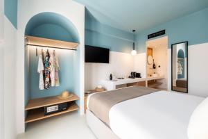 a bedroom with a bed and a bathroom at Play Paros in Kampos Paros