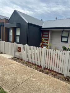 a white picket fence in front of a house at 12 Stern Way New Gisborne in Gisborne