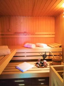 a sauna with two beds and a table in it at Seoska vila Vallis Aurea in Kaptol