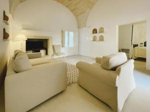 a living room with two couches and a fireplace at Masseria Paralupi in Lecce +46 photos