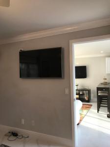 a living room with a flat screen tv on a wall at The Havens hideaway in Freeport