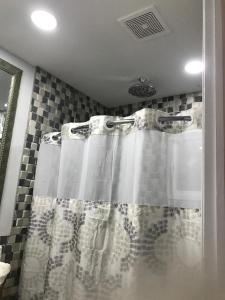 a shower with a shower curtain in a bathroom at The Havens hideaway in Freeport
