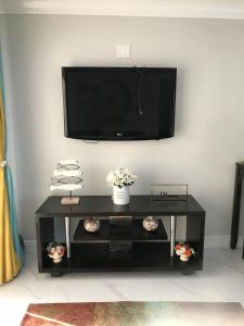 a black coffee table with a flat screen tv on a wall at The Havens hideaway in Freeport