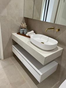 a bathroom with a white sink on a counter at 12 Stern Way New Gisborne in Gisborne