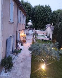 a courtyard of a house with benches and a building at Les Tilleuls in Cavaillon