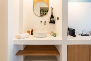 a bathroom with a sink and a mirror at Play Paros in Kampos Paros
