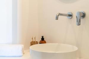 a bathroom with a white sink and a faucet at Play Paros in Kampos Paros