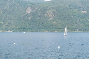 two boats in a large body of water with mountains at Rivalago B&B in Cannobio