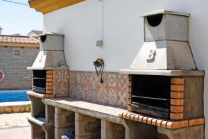 an outdoor pizza oven sitting on a patio at Magnolia B- Solo Familias in Conil de la Frontera