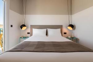 a bedroom with a large bed with two tables at Play Paros in Kampos Paros