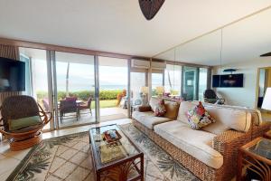 a living room with a couch and a table at Island Sands Resort 111 in Wailuku