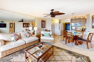a living room with a couch and a table at Island Sands Resort 111 in Wailuku