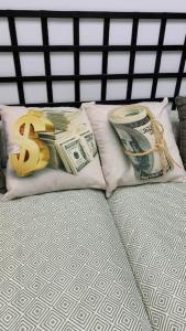 a pile of money on a pillow on a bed at Apto. Singular en la Mancha Banco de Inversiones in Argamasilla de Alba