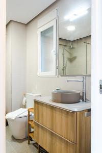 a bathroom with a sink and a toilet at Myflats Premium Beach Front in Arenales del Sol