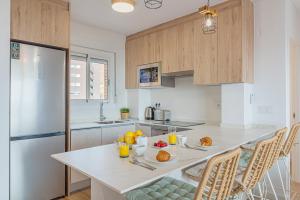 a kitchen with a table with plates of food on it at Myflats Premium Beach Front in Arenales del Sol