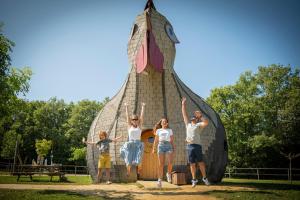 a group of people standing in front of a play structure at Village Vacances - DéfiPlanet' in Dienné