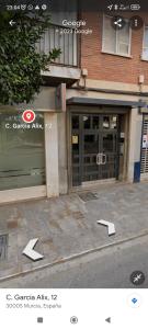 a store front with two doors with arrows pointing into it at Lujoso apartamento junto a Museo Salzillo in Murcia