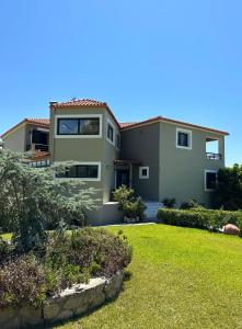 a large house with a green yard at Pagonis Studios in Lixouri