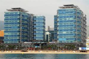 two tall buildings on a beach next to the water at Haeundae Luxury House in Busan