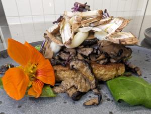 a pile of food with a flower on a table at Hotel Am Fleesensee in Malchow