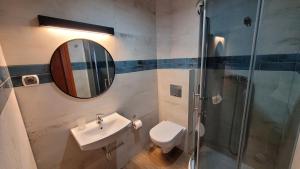 a bathroom with a toilet and a sink and a shower at Villa Bri in Łeba +39 photos