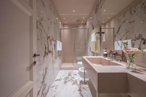a bathroom with a sink and a toilet and a mirror at Apartments Florence - Palazzo Signoria luxury Apartments 11-Medusa in Florence