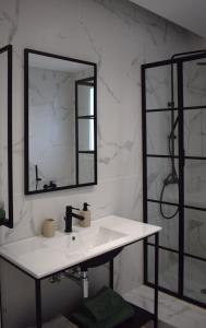 a bathroom with a sink and a mirror at SeaView Apartment Megas Limnionas in Chios