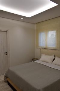 a bedroom with a large bed with a ceiling at SeaView Apartment Megas Limnionas in Chios