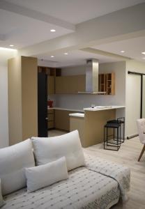 uma sala de estar com um sofá branco e uma cozinha em SeaView Apartment Megas Limnionas em Quios