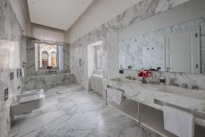a white bathroom with two sinks and a tub at Apartments Florence - Palazzo Signoria luxury Apartments 1-Biancone in Florence +41 photos