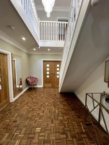 an empty hallway with a staircase in a house at Large 4 bedroom house, electric gated driveway. 