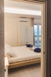 a bedroom with a large bed and a window at La Vista Formia B&B in Formia