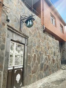 a stone building with a sign above a door at REAL FAMILY APART new in Soğuksu