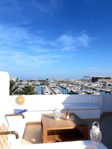 a balcony with a table and a view of a harbor at MiCasaDenia in Denia