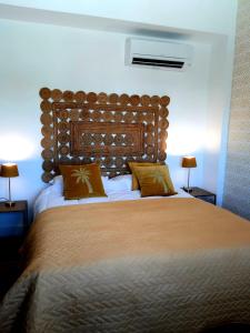 a bedroom with a large bed and two lamps at MiCasaDenia in Denia