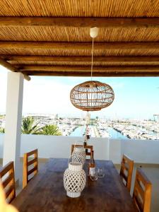 a dining room with a table and a chandelier at MiCasaDenia in Denia