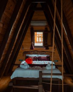 a attic room with a bed and a window at Keyfi Teras Bungalov in Rize