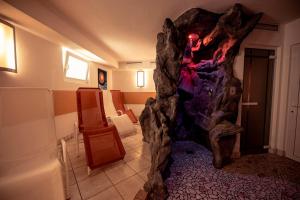 a room with a rock formation in the middle of a room at Roanerhof in Campo Tures