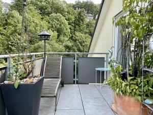 a balcony with two chairs and a table and some plants at Guest Room in Stuttgart-Nord in Stuttgart