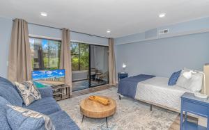 a bedroom with a bed and a living room at Fully Renovated First Floor Condo! Cypress Bay J-2 in Little River
