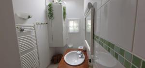 a bathroom with a sink and a toilet and a shower at Honfleur à deux in Honfleur
